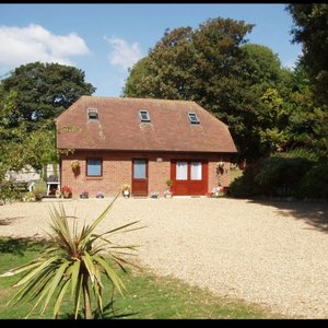 This little cottage has one double and one twin room, a sitting room, 2 shower rooms and a fully equipped  kitchen with table and chairs and washing machine. It is set in a large garden of nearly an acre.