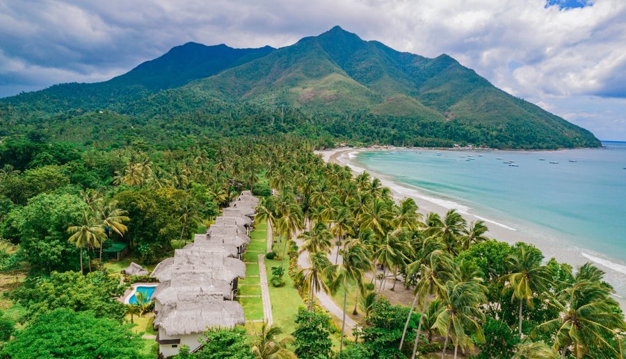 Drone shot of Daluyon Beach and Mountain Resort with the overlooking mountain view of Bloomfield and Sabang Beach