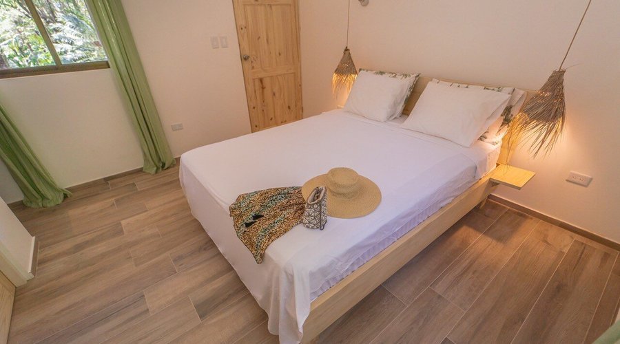 Hotel Entre Dos Aguas, Samara, Costa Rica Room - El Nido  ... our brand-new, modern room, designed to captivate with its abundant natural light, private balcony, and captivating jungle views. Embrace the allure of this beautifully bright and modern retreat, offering a serene and stylish setting for your stay. •	Sleep - 2 •	Queensize •	Private Bathroom •	Safe •	Shared Kitchen •	18m² •	Air conditioning •	Wi-Fi •	Refrigerator •	Upper Floor 