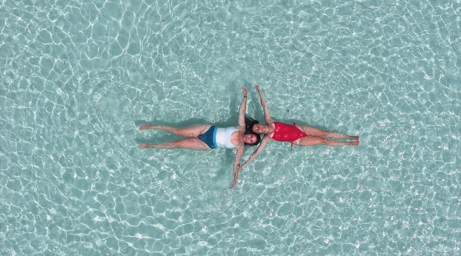 two Guests floating on the sea near Sand bank.