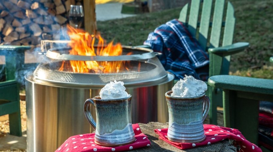 Enjoy a cup of hot cocoa by the fire, complete with whipped cream, for the perfect treat on a chilly evening.