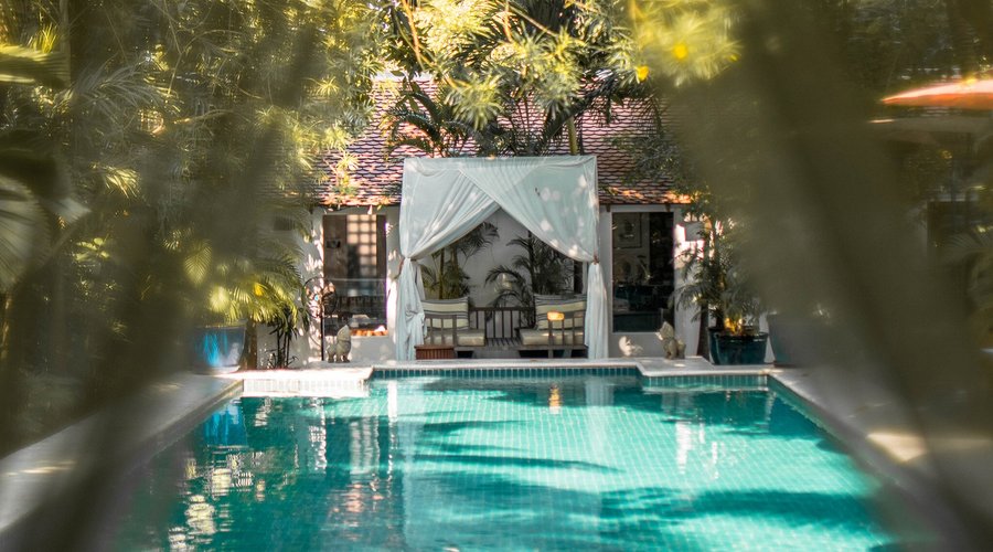 The cabana and pool, where greenery meets the water.