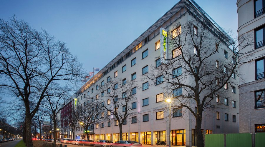 Holiday Inn Express on a broad, tree-lined boulevard in Berlin.