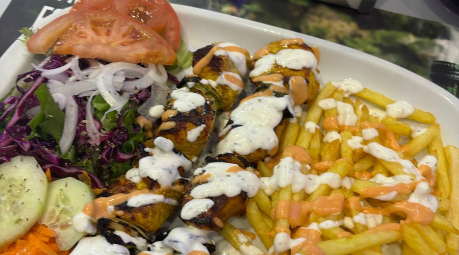 Grilled chicken kebab with chips, salad and the garlic and chilli sauce