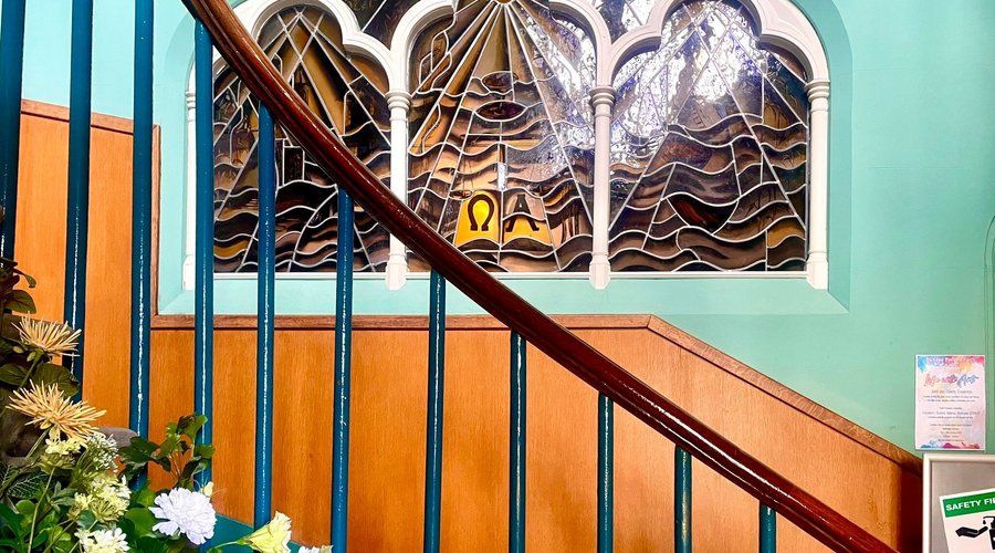 Not only are the stained glass windows beautiful, but so is the artfully crafted lattice woodwork upon the domed ceiling.