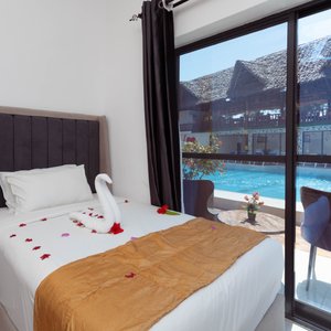 The 50 m2 Room comes with three Single beds with a private bathroom, balcony, cattle, smart TV, WIFI, mini fridge, and a Terrace with a lovely view from our garden. 