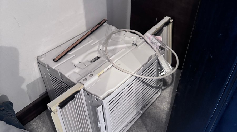 Air conditioning window unit, disconnected on floor in closet