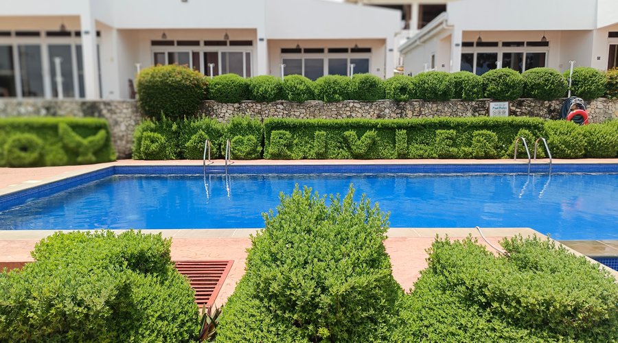 Experience a relaxing retreat at The Gabayan Riviera Resort, featuring a serene outdoor pool surrounded by lush greenery and stylish architecture. The crystal-clear waters offer a refreshing escape, perfect for cooling off on a sunny day. The beautifully manicured hedges spell out "Gabayan Riviera," adding a charming touch to the poolside ambiance. With modern accommodations just steps away from the pool, this resort creates an ideal setting for both relaxation and enjoyment.
