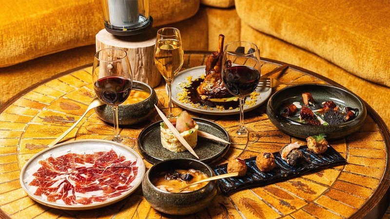 Table topped with tapas and glasses of wine