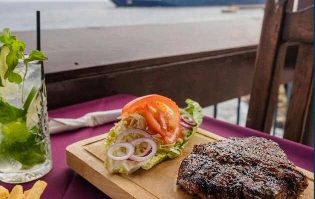 The best view on the island accompanied by a juice and tender steak.