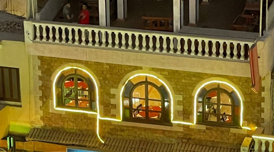 The brilliance of Jamboree restaurant at night amidst the crowd of pedestrians in the old Luxor market