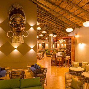 Unwind in the cozy lounge at Acacia Seronera Luxury Camp, where plush seating and stunning Serengeti views offer the perfect spot to relax after a day of adventure.