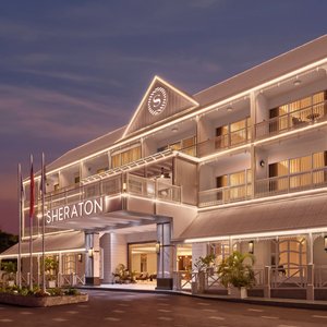 Grand resort frontage with tropical surroundings.
