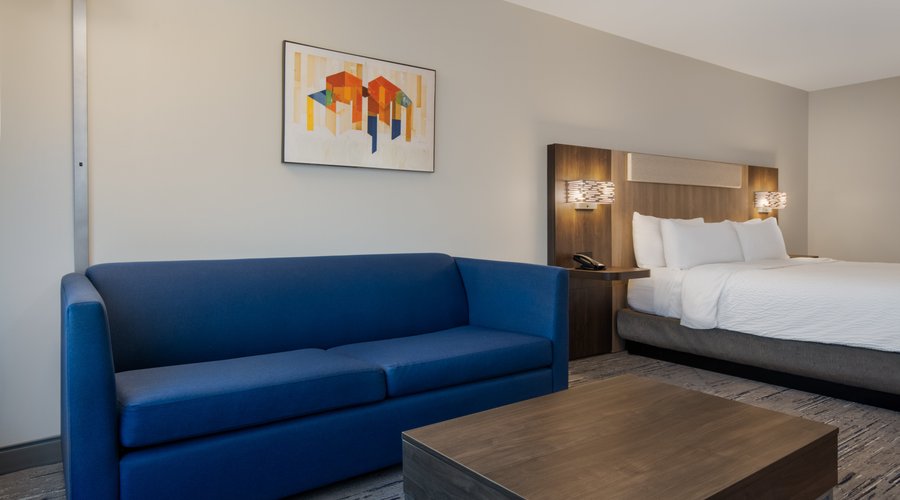 guest room with king bed and sofa
