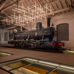 Captured from a stunning angle, the iconic Locomotive (2-6-0 Model), crafted by Arnold Jung in 1906, takes center stage inside Prima Classe. This masterpiece, which arrived at Hegra in 1907, stands as a symbol of the region's rich history, seamlessly blending with the modern ambiance of the restaurant.