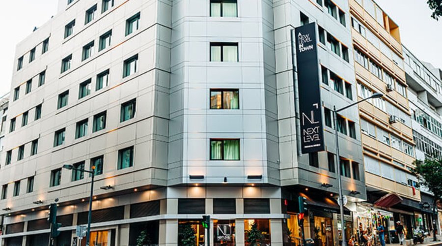 Exterior view of Next Level Premium Hotels, showcasing its modern design and luxurious comfort. Conveniently located on a tree-lined street near Marquês de Pombal, the hotel is surrounded by shops, dining, and local attractions, offering easy access to everything you need. Experience premium comfort and exceptional service at Next Level.
