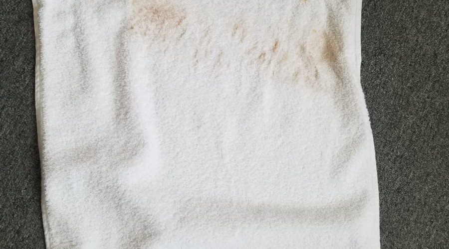 Towel stained from dirty shower wall