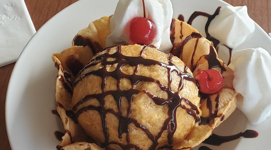 Fantastic fried ice cream.   Crispy shell and the ice cream was exactly as I remembered.   The fried coating wasn't overly sweet but it adhered to the scoop of French vanilla so well...the chocolate drizzle complimented the dessert.  Definitely a sharable treat!