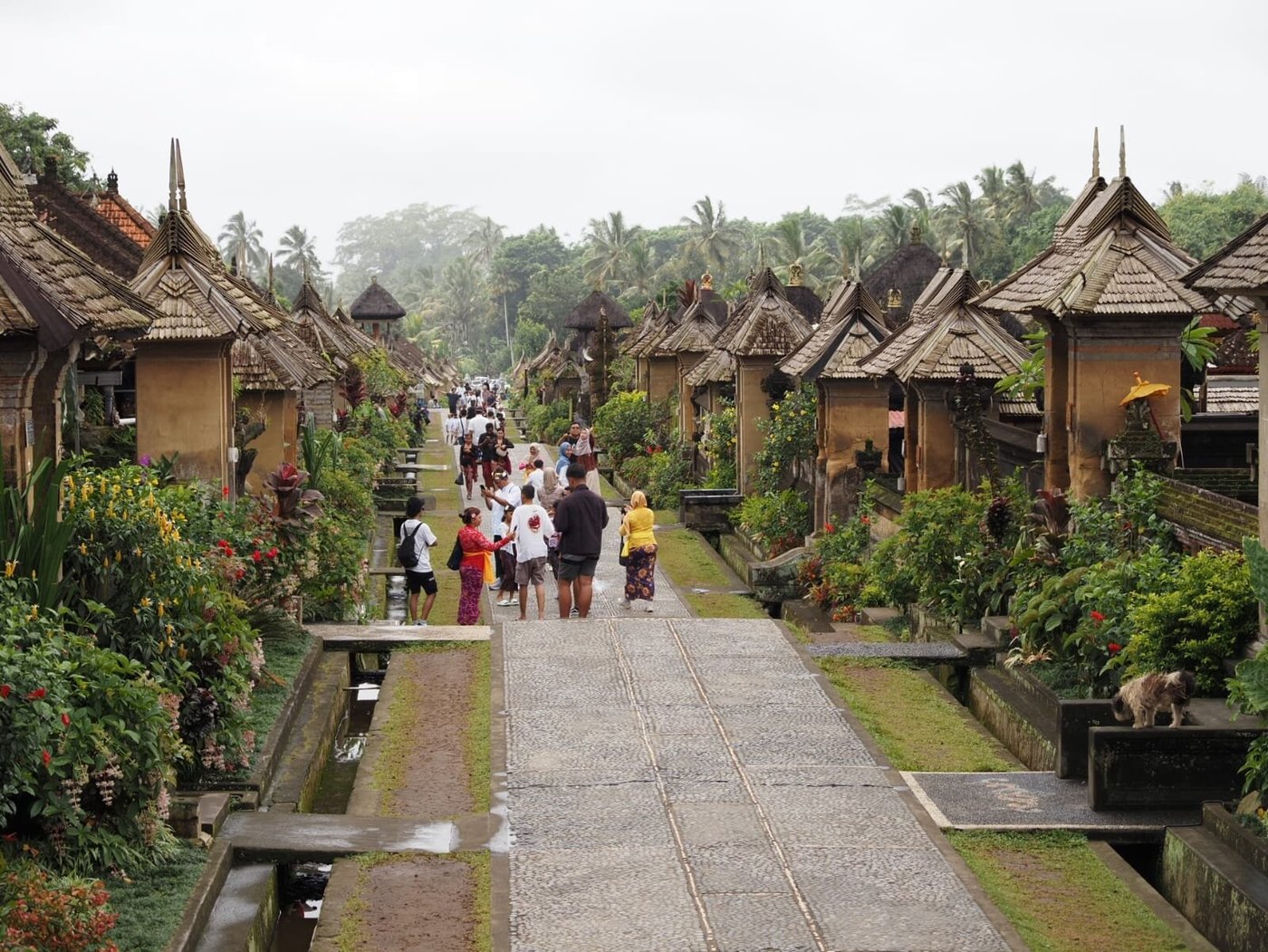 Traditional bamboo house with thatched roof and ornate entrance gate