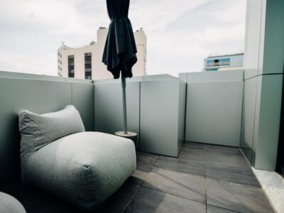 Relax on the private balcony of our Double Room with Balcony, offering beautiful views and fresh air for your comfort.