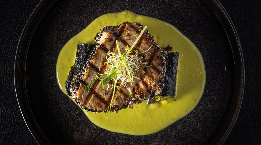 Wasabi Grilled Yellowfin Tuna. Grilled yellowfin tuna with a sesame crust, wasabi sauce, and seaweed-wrapped vegetable rolls.