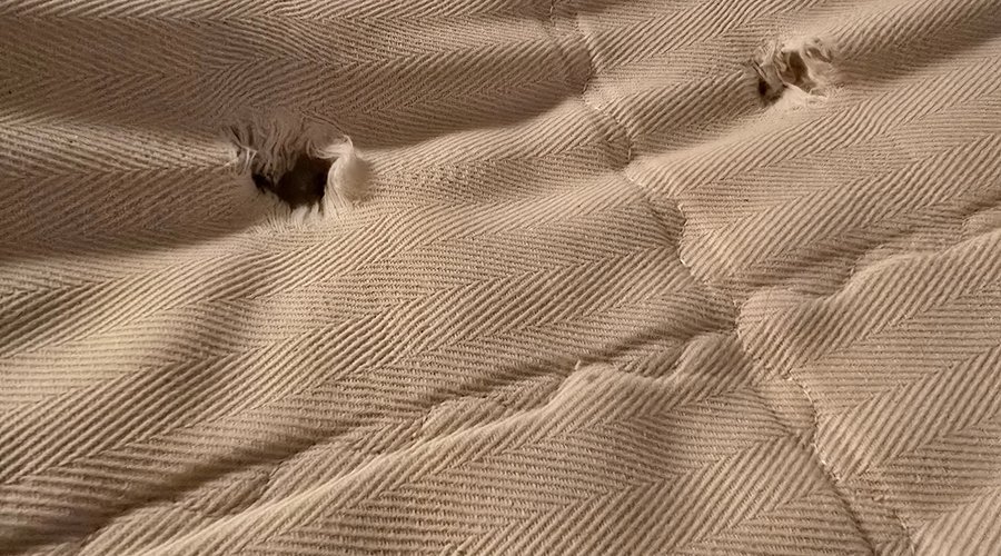 Holes in the mattress and metal spring hit your back.