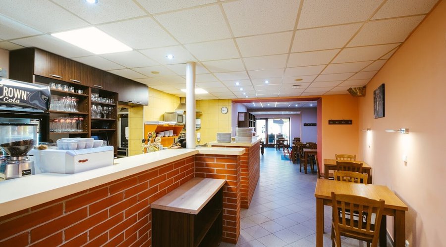A cozy and welcoming interior with an open kitchen, where your food is prepared fresh right in front of you. 