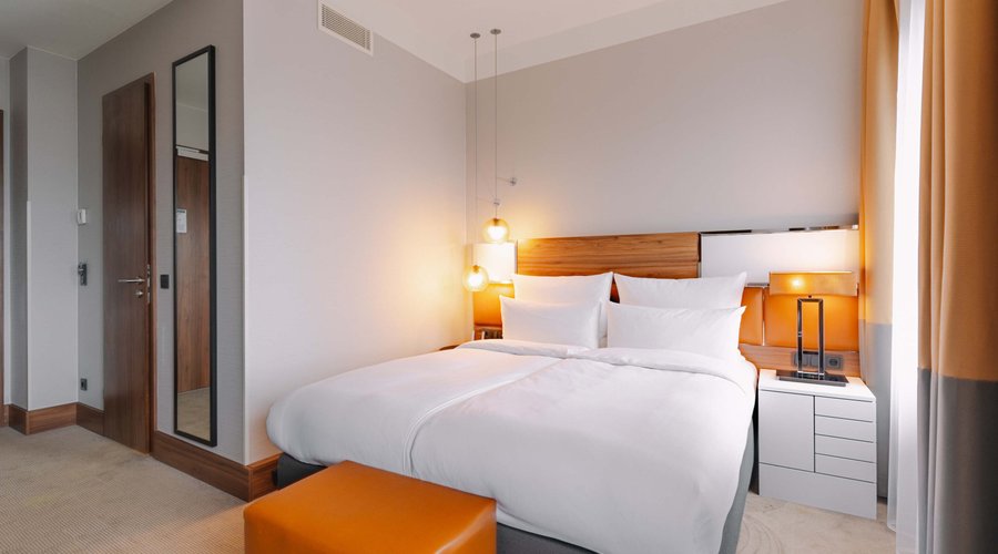 Medium Room Boasting stylish art-déco design and high ceilings, guests can enjoy a luxurious bed, large working desk and marble bathroom complete with a rainfall shower.