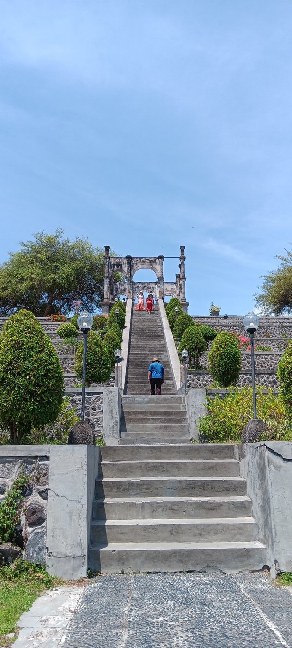 Stunning water palace with white pavilions floating on serene pools connected by traditional bridges
