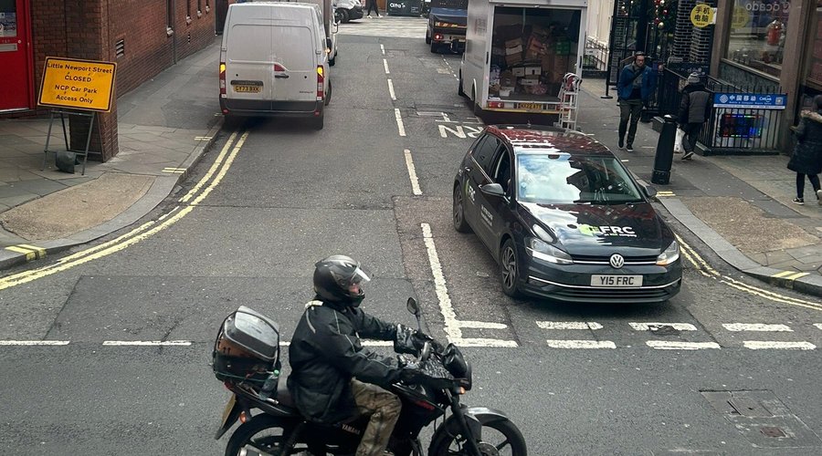 Two photos- one of a motorcycle and another of two bicycles, as seen from the upper deck of the double-decker bus