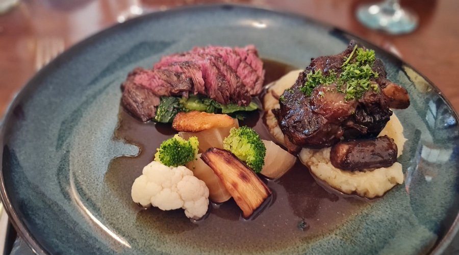 Duo of beef - medium rare skirt and braised oxtail on mashed potato, with local parsnips, cauliflower, brocolli, cabbage, sprouts and white beetroot.   All brought together by an amazing jus.  Apologies for no photos of desserts - the passion fruit and white chocolate souffle was pure theatre.