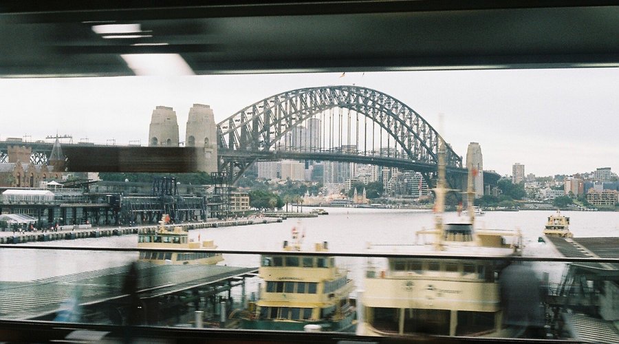 Analog photography inside a train arriving to Circular quay station. Clear view of harbour bridge.