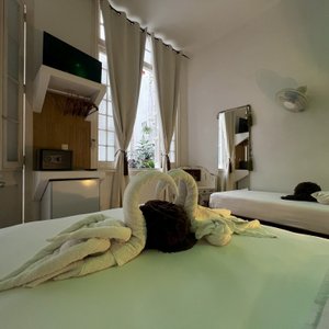 Enjoy our house with your family and friends These are ideal and spacious rooms for families or friends who travel together. The decoration and glass walls in the bathrooms are among the unique peculiarities. They are located on the ground and first floor. Each room has a refrigerator, air conditioning, TV, safe deposit box, hair dryer, own private bathroom and two beds: a double and a single; specifically designed for each room.