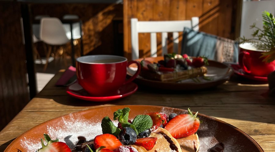 Pancake with whipped cream and fruits