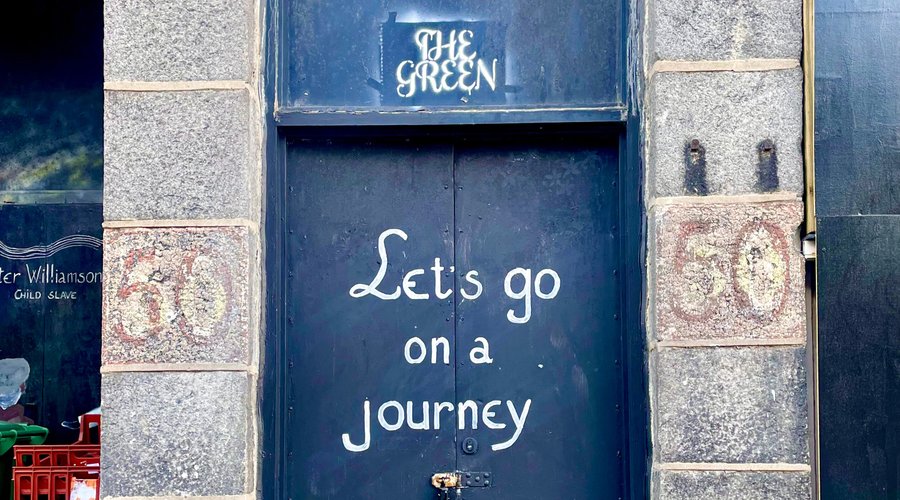 Mottos written on a door in The Green. 
