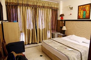 Megha Homestay in New Delhi, image may contain: Furniture, Bed, Bedroom, Indoors