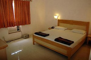 Hotel Shubham Holidays in Vrindavan, image may contain: Bed, Furniture, Resort, Hotel