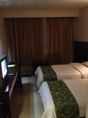 Hotel Grand Antares in Medan, image may contain: Screen, Monitor, Computer Hardware, Bed