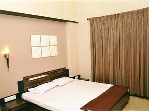 Hotel Ajanta in Jalgaon, image may contain: Interior Design, Hotel, Bed, Resort